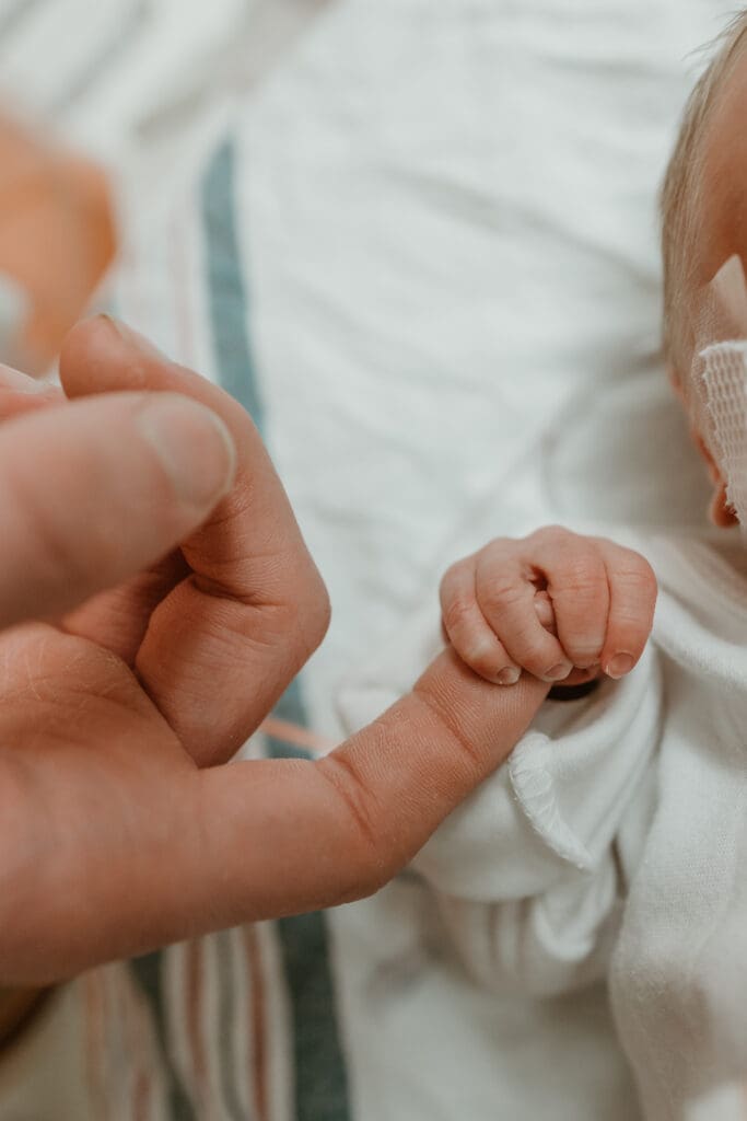 fresh 48 image of baby in nicu holding onto dad's finger