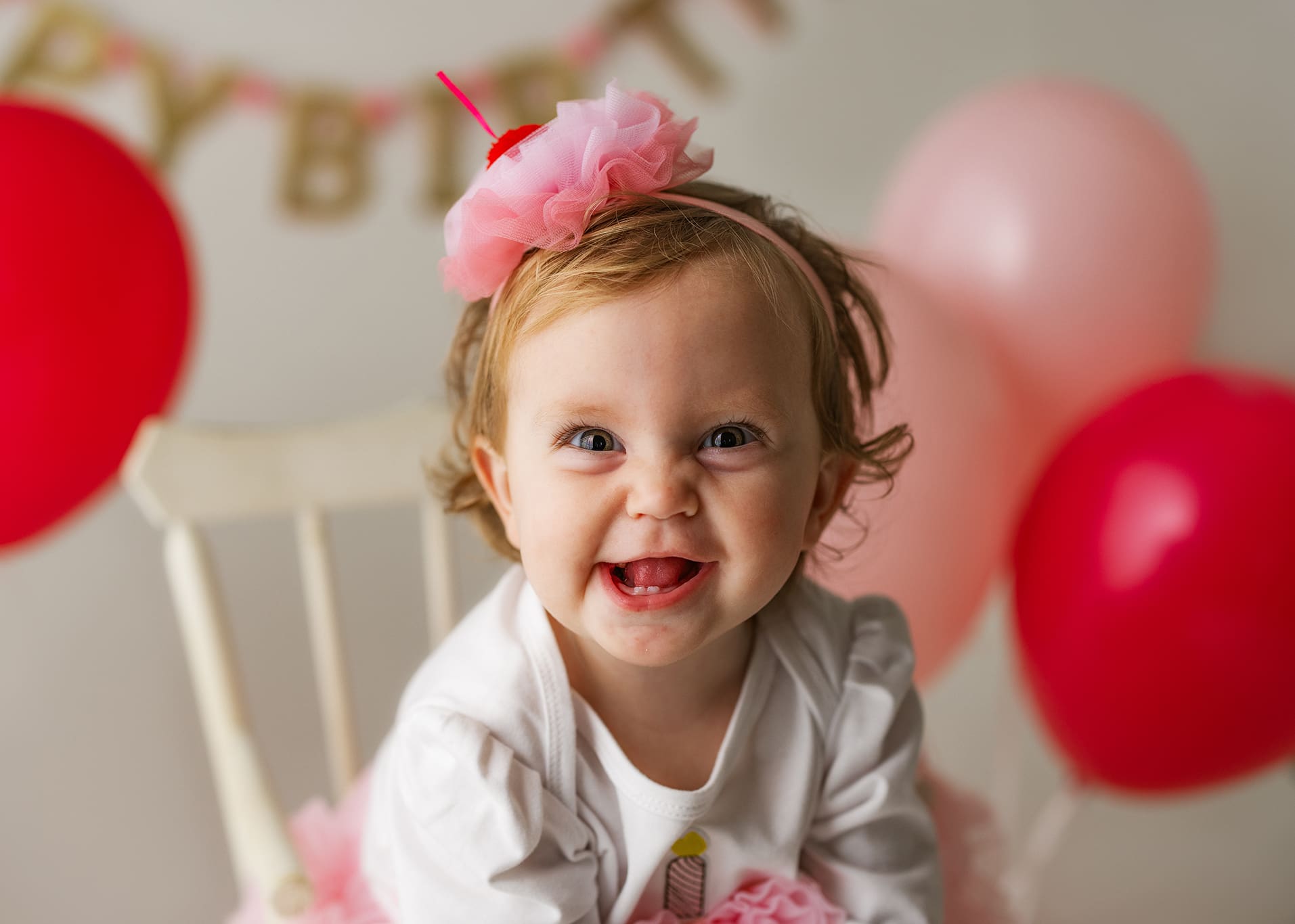 Looking for first birthday photography in Clarksville TN? This simple one-year milestone session features a neutral lifestyle setup and a sentimental heirloom outfit, creating timeless photos without a cake smash.