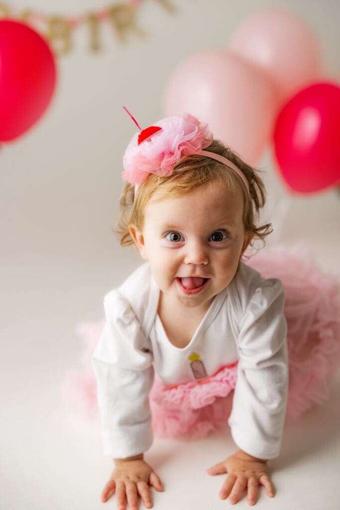 a one year old girl enjoys her birthday photo session 