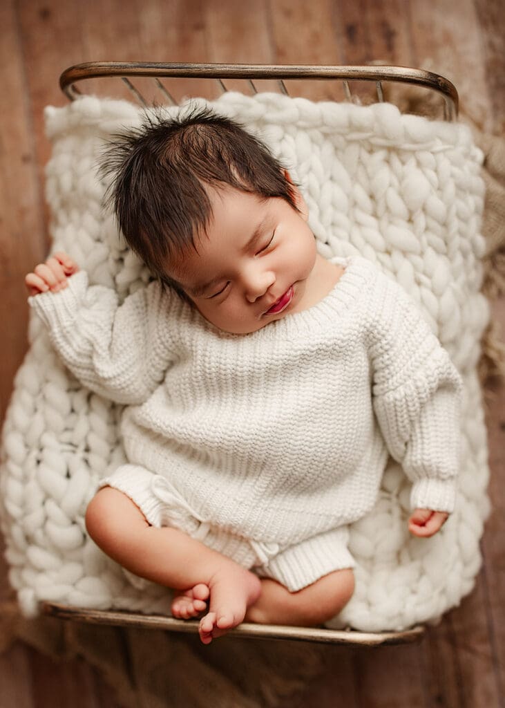 image of a relaxed newborn baby boy taken during his newborn photography session