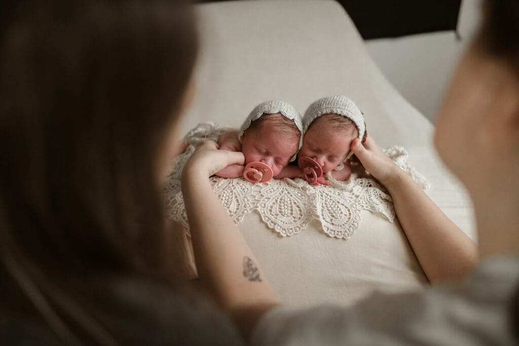 Photographer Jess Pearson poses twin newborns during a session in Clarksville TN