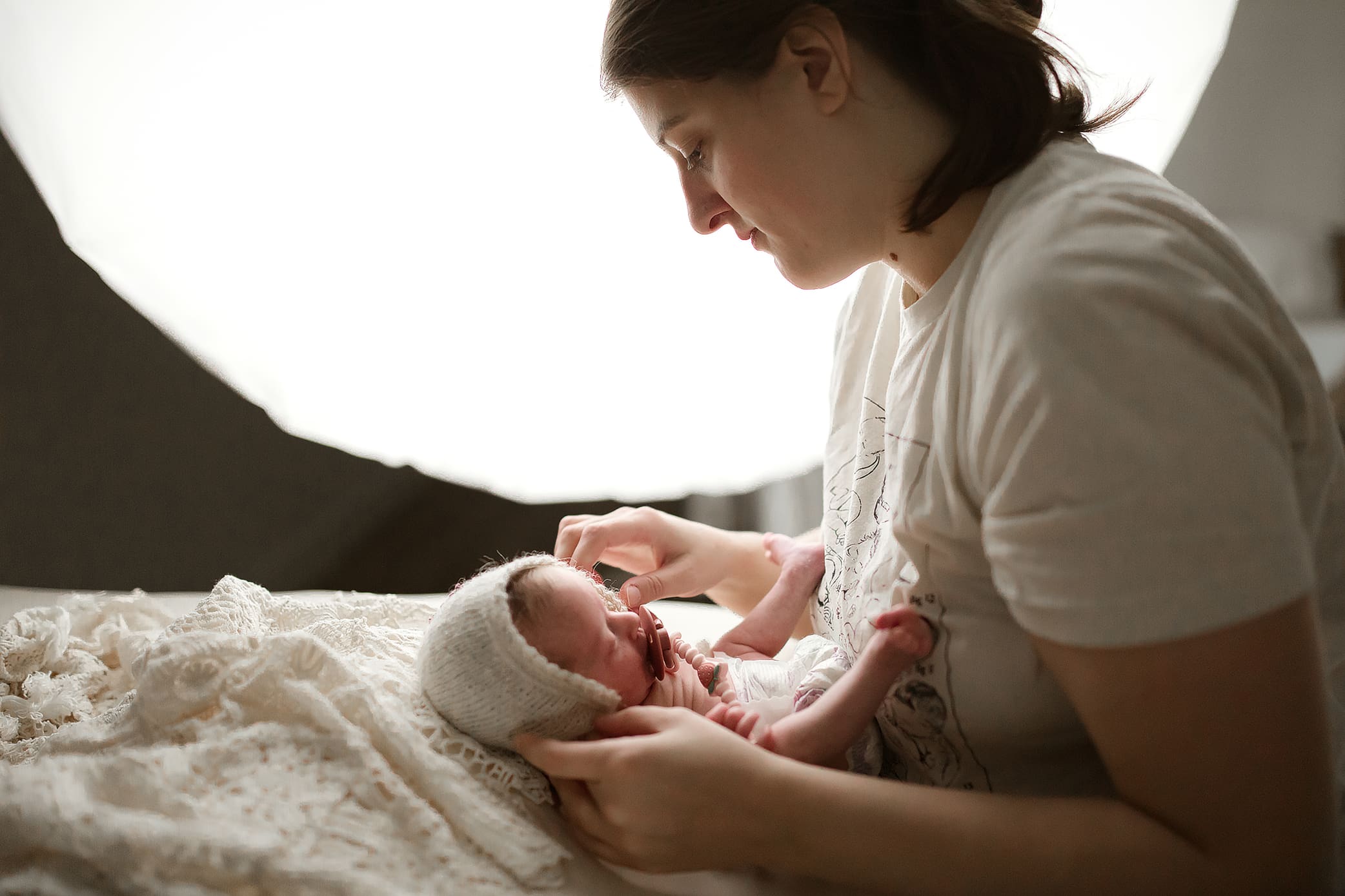 Clarksville TN newborn photographer Jess Pearson getting baby ready for a photo during newborn session