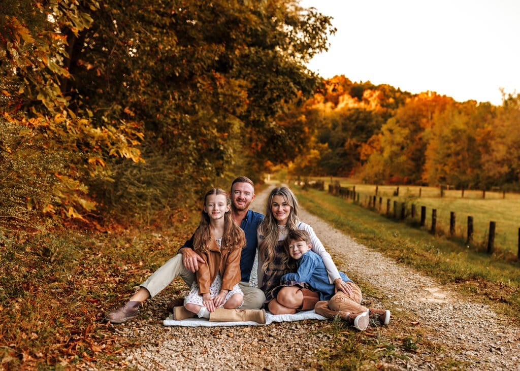 family smiling at camera during family session
